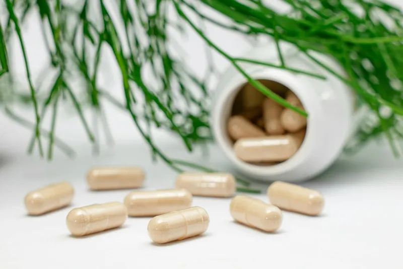 Probiotic capsules and fermented foods on a table