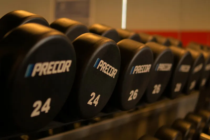 Pre-workout powder and shaker bottle on a gym bench before training