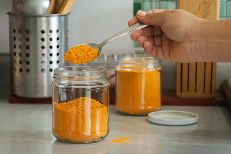 Yellow curcumin powder and supplements on a table