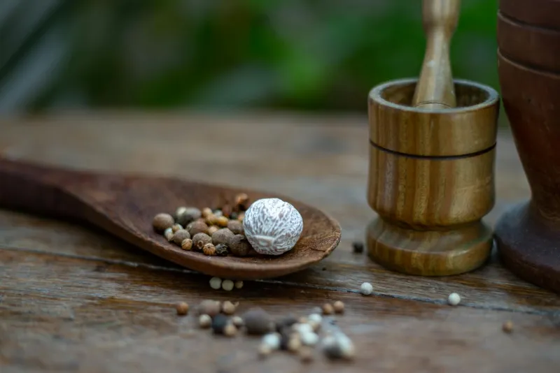 Maca root powder and capsules on a table