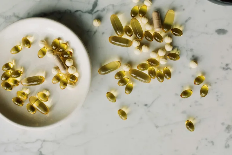 Woman examining hair loss signs related to biotin deficiency