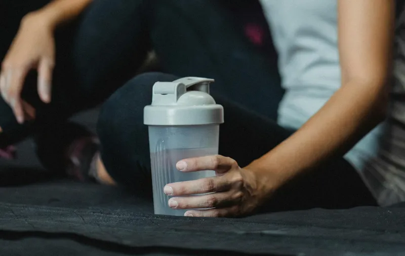 Creatine powder and sports supplements on gym table