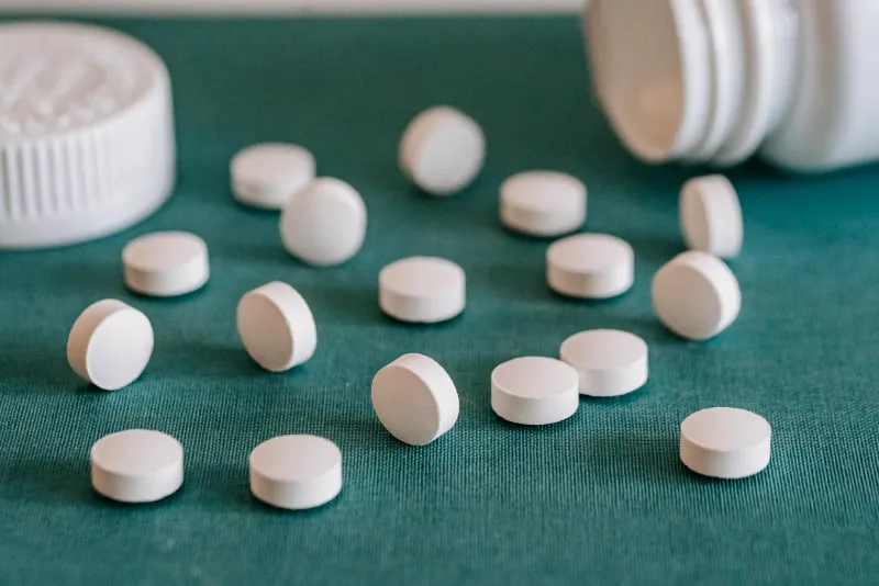 Sleep supplements — melatonin capsules and sleep support on a nightstand