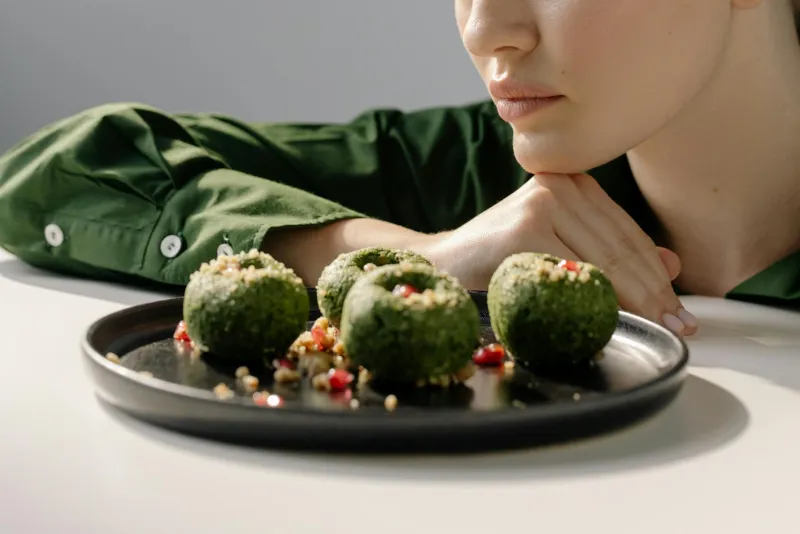 Chlorella green powder and capsules on a natural background