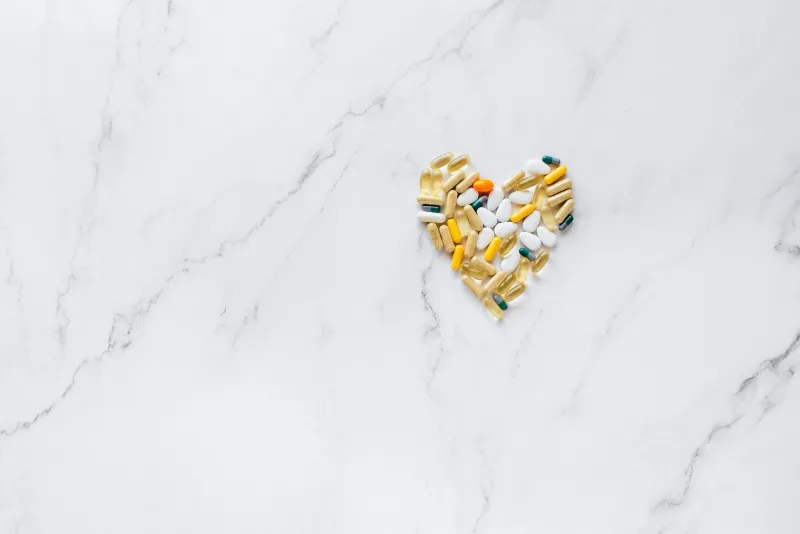 Supplements on a table with nutrient-rich foods illustrating inositol interactions