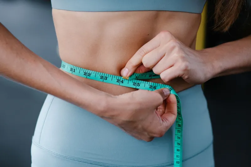Woman exercising on treadmill with sports supplements