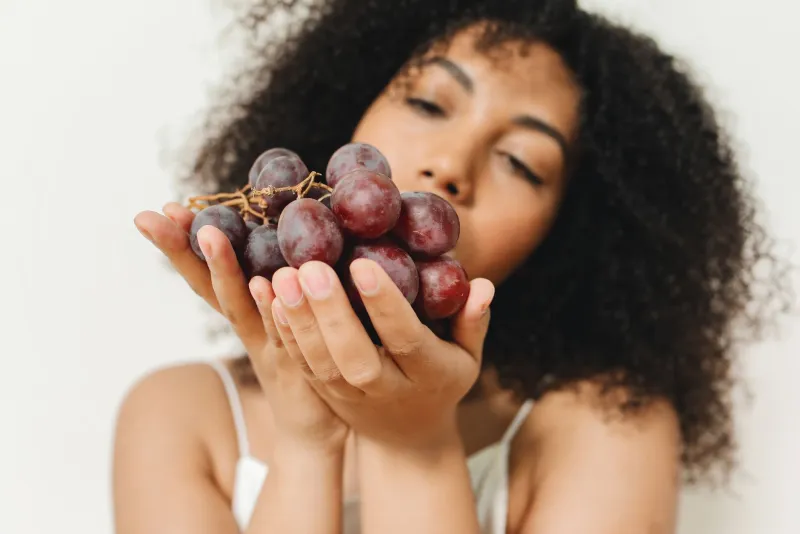 Resveratrol capsules and grapes on a table