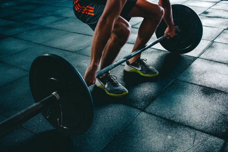 Creatine powder and strength training equipment