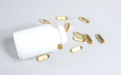 Supplement capsules spilling from a bottle - amino acid supplement