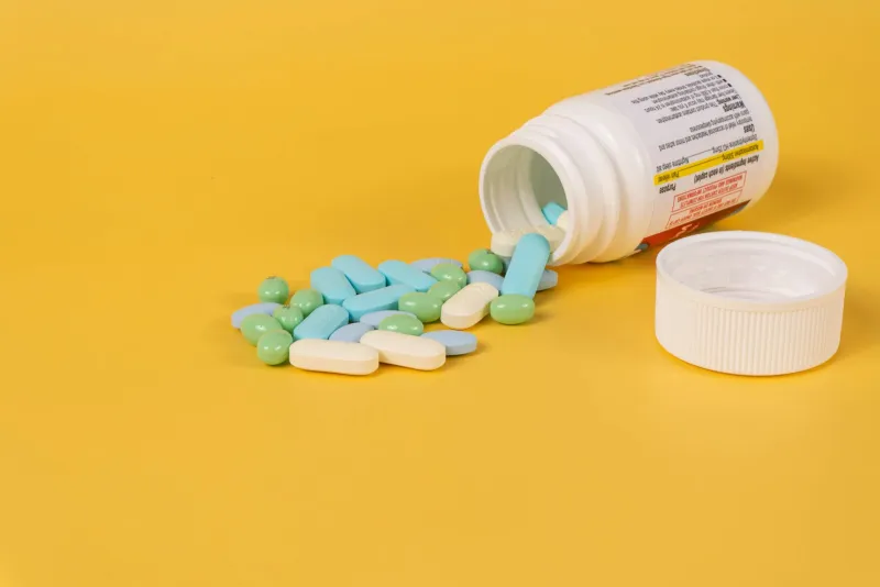 Tryptophan capsules and a small piece of fruit on a table for sleep support